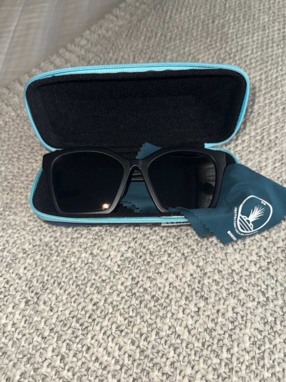 Black Rheos Polarized Sunglasses with Teal Case